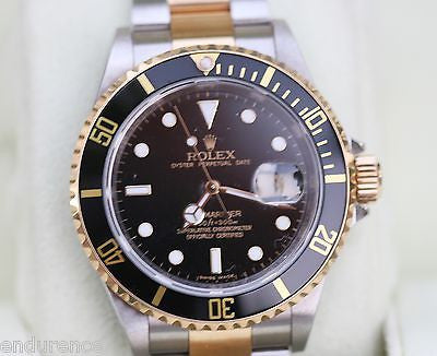 ROLEX SUBMARINER TWO TONE GOLD STAINLESS STEEL BLACK ON BLACK WATCH 16613
